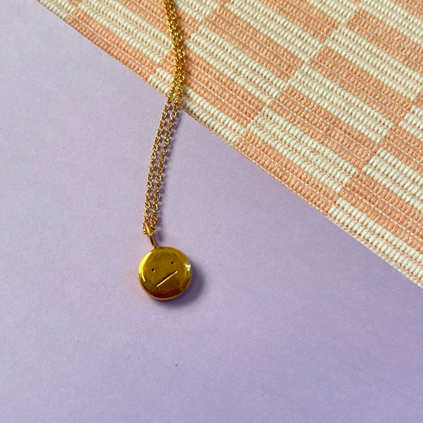 Gold plated “meh” smiley