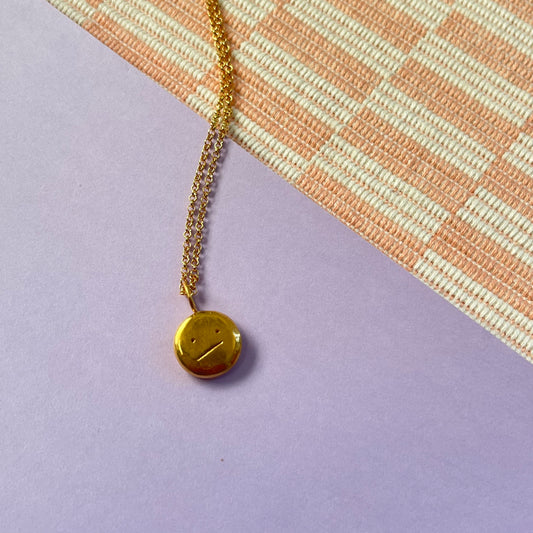 Gold plated “meh” smiley
