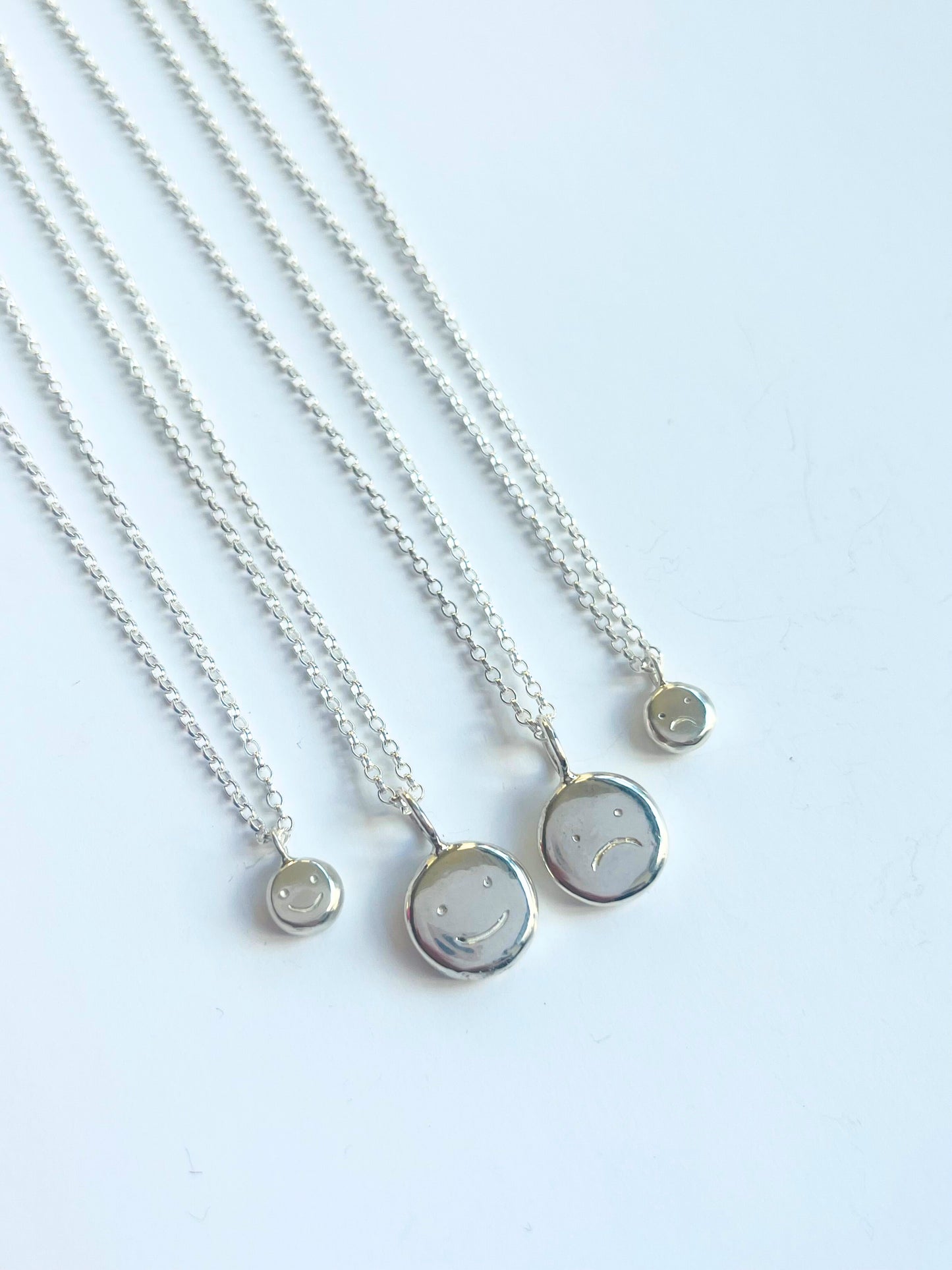 Silver baby "moodflip" smiley pendant