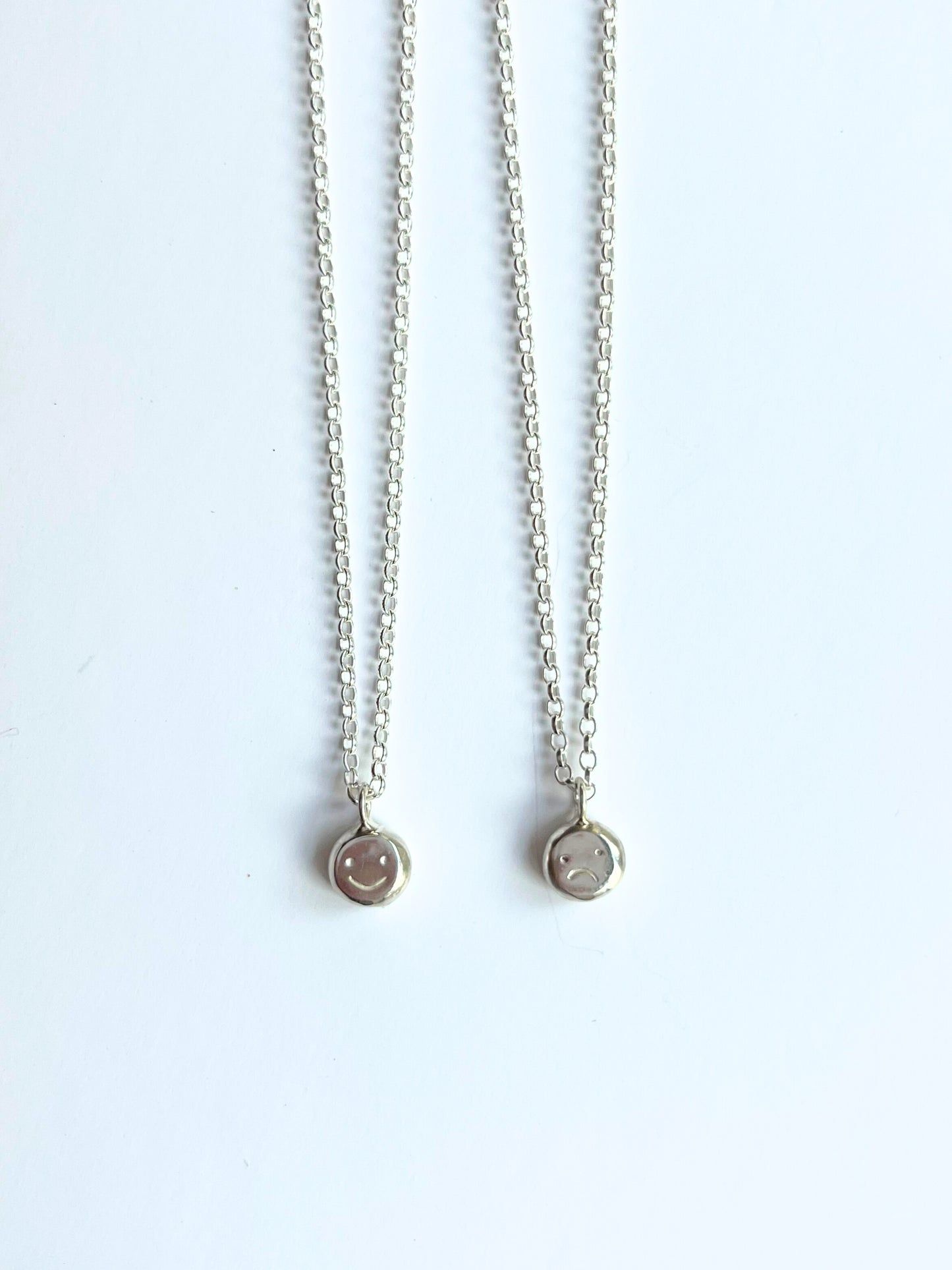 Silver baby "moodflip" smiley pendant